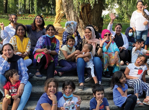 newcomer women and children having fun in a park