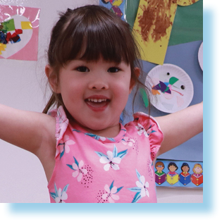 young smiling girl in child care room