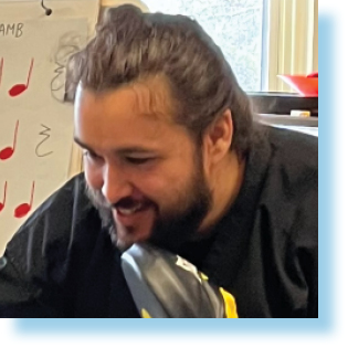 young man teaching a child how to box in an extracurricular sports program