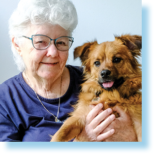 elderly woman holding a dog