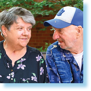 elderly woman and man looking at each other tenderly