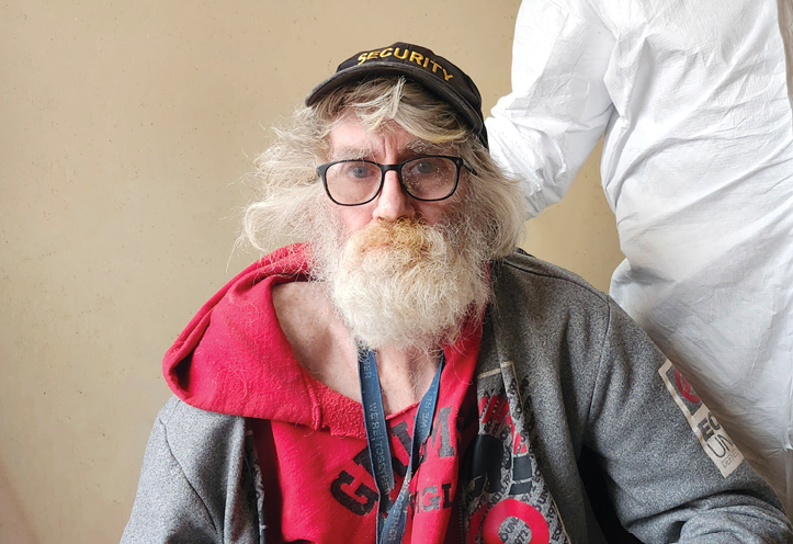 older man sitting next to a Personal Support Worker