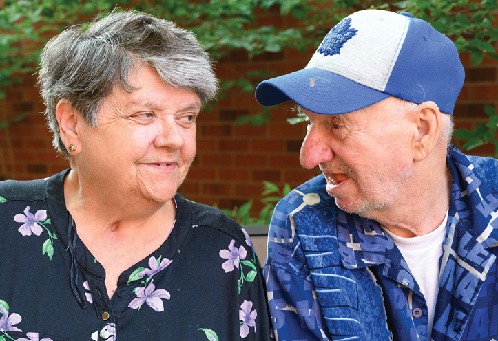 elderly woman and man looking at each other tenderly