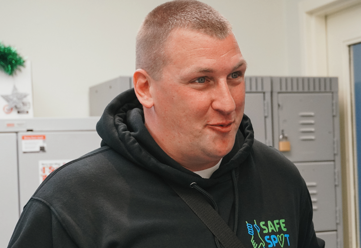 smiling man wearing a Safe Spot hoodie