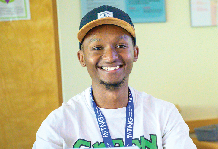 smiling young man in a baseball cap