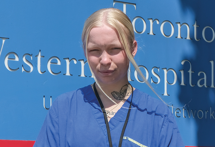 young woman standing in front of Toronto Western Hospital sign