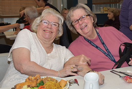 seniors smiling at a table