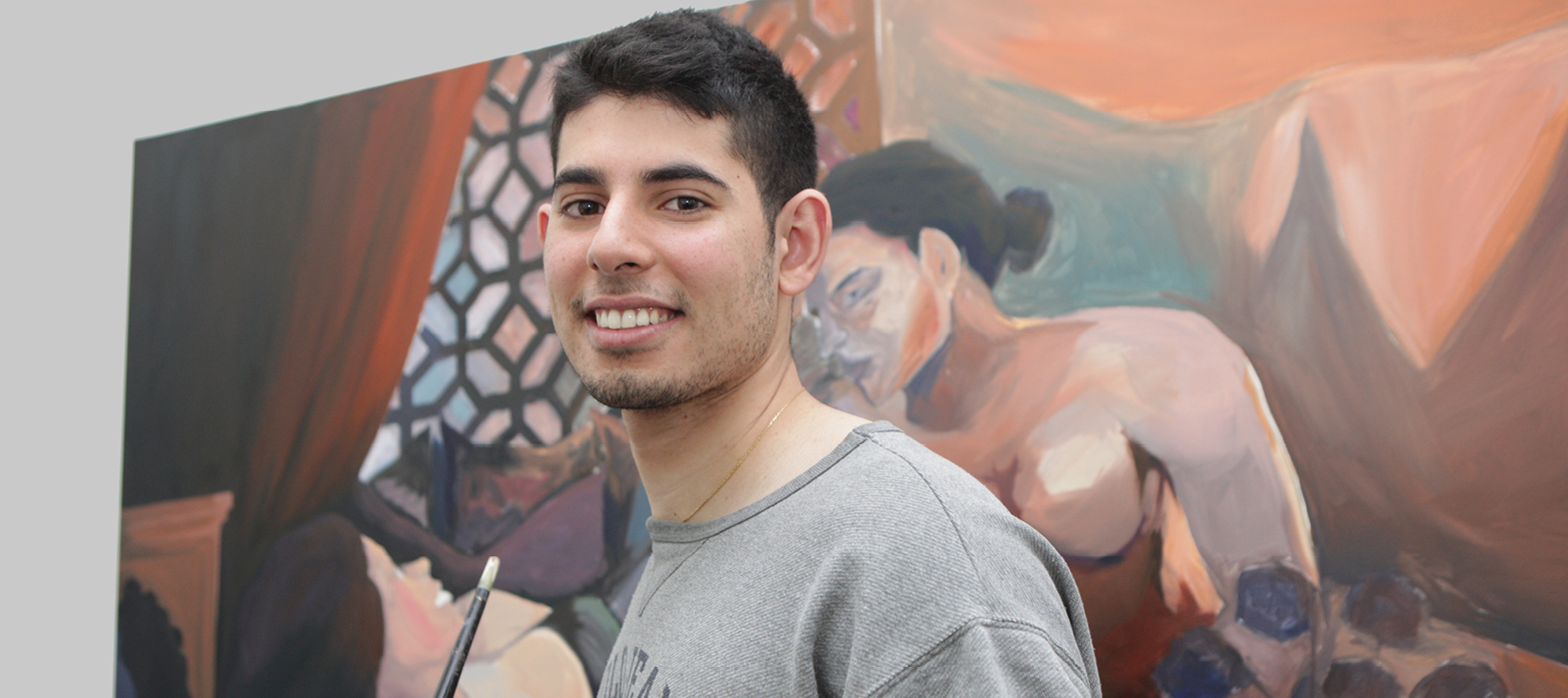 youth artist in front of his painting at the Youth Arcade Studio