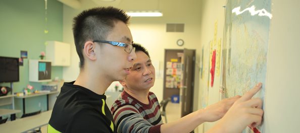 youth pointing at map in North York Newcomer Centre
